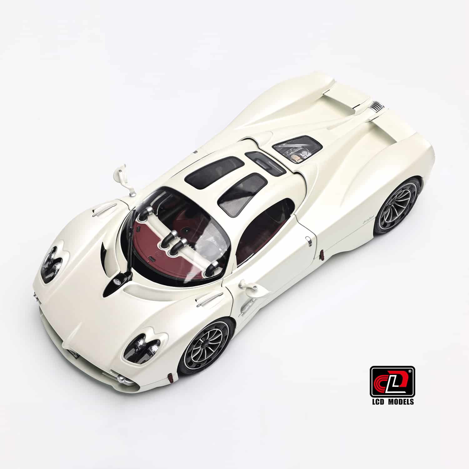A high-angle overview of the 1:18 Pagani Utopia in Pearl White, highlighting the combination of painted bodywork, glass, and carbon fiber.