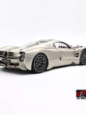 The muscular form of the 1:18 Pagani Utopia diecast in Rinascimento Lucido, seen from the rear three-quarter angle to show off its curves.