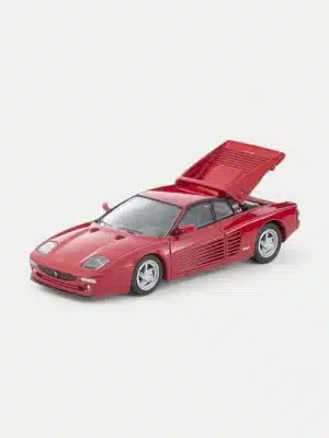 The 1:64 Ferrari with opening engine cover, the F512 M by TOMYTEC, revealing the detailed flat-12 engine replica within.