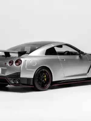 The iconic rear three-quarter view of the Nissan GT-R R35 NISMO model in 1:18 scale, highlighting the signature quad taillights and carbon fiber rear bumper.