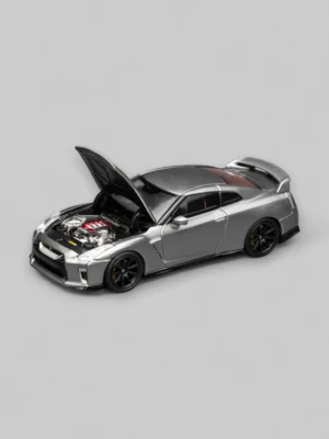 A Motorhelix 1:64 GT-R R35 model with its hood open, showcasing the meticulously detailed VR38DETT engine replica within.