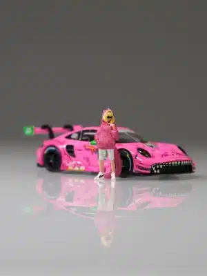 Moreart 1:64 Roxy figure displayed next to the pink Mini GT AO Racing 'Roxy' Porsche 911 GT3 R model car.