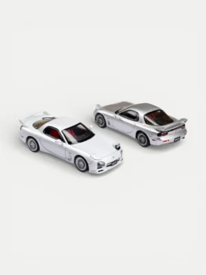 Rear view of two Focal Horizon FH 1:64 Mazda RX-7 diecast models showing the Mazdaspeed A-Spec wing and metal exhaust details.