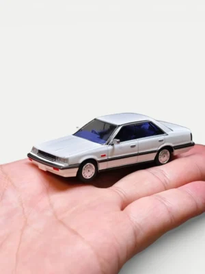 Side profile of the 1985 Nissan Skyline Hardtop model showing precise 1:64 scale proportions and classic wheel design.
