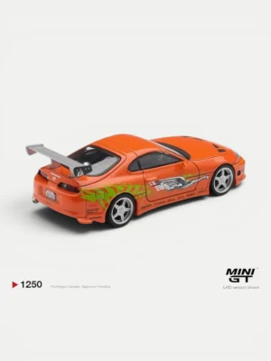 Rear view of the 1/64 scale BOMEX Supra model car by MINI GT, detailing the massive rear spoiler and custom exhaust.