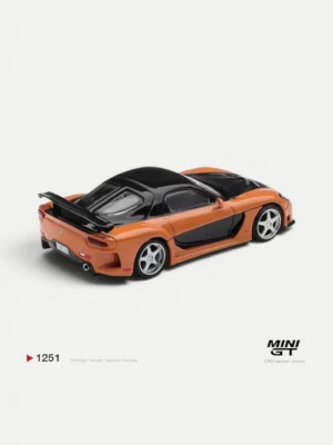 Rear angle of MINI GT 1251 Mazda RX-7 VeilSide diecast. Showcasing the iconic Tokyo Drift custom spoiler and widebody.