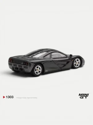 Rear angle of the black McLaren F1 diecast by MINI GT. Highly detailed 1/64 scale model showcasing authentic taillights.