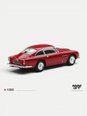 Rear angle of the 1/64 scale MINI GT Aston Martin DB5 Fiesta Red showing detailed taillights and dual exhausts.