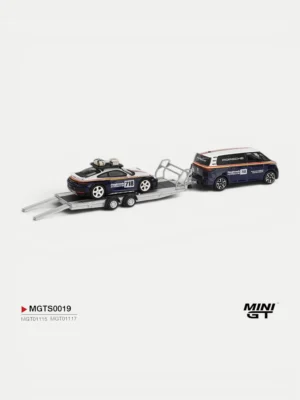 Rear view of the 1/64 VW ID. Buzz towing the Porsche 911 Dakar on a trailer, showcasing detailed Roughroads liveries.