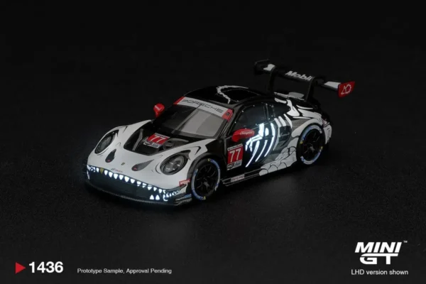 MINI GT #1436 1:64 Porsche 911 GT3 R (992) #77 AO Racing "Skeleton Rexy" 2026 IMSA Petit Le Mans (Glow-in-the-Dark / Glow Rexy)